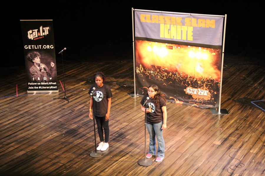 Jadesola Ajileye and Amanda Jimenez preforming a duet. Their classic was America by Fatimah Asghar with their response titled  Black Girl Tragic.