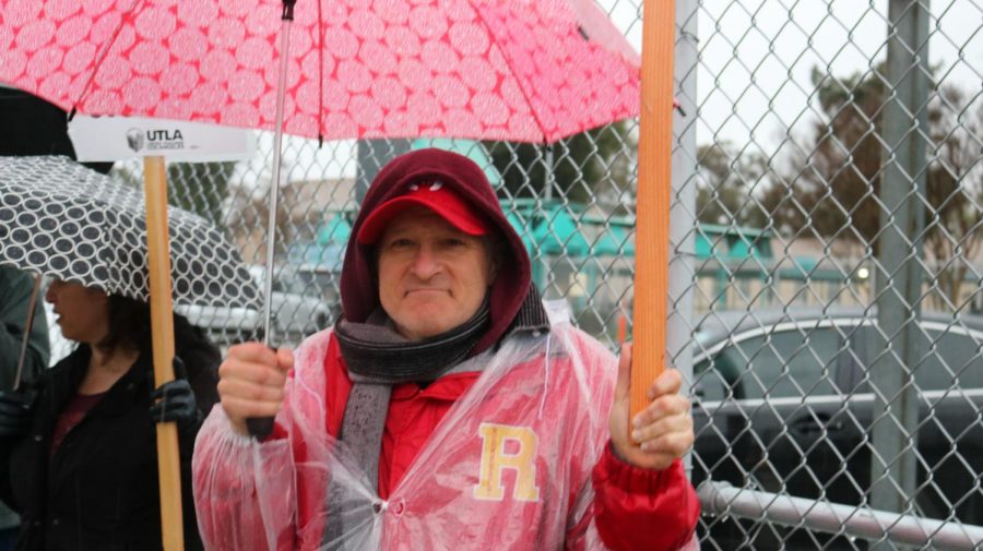 English teacher Ron Baer joins the protest despite the foul weather.